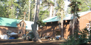 Two buildings in a forest of trees at Camp Cole